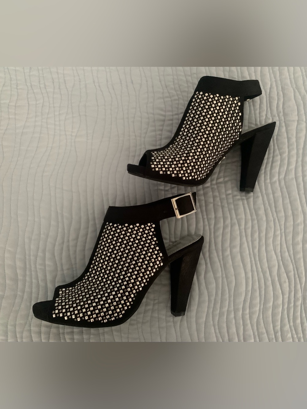 Black heels with silver stud detailing. Size 6.5.